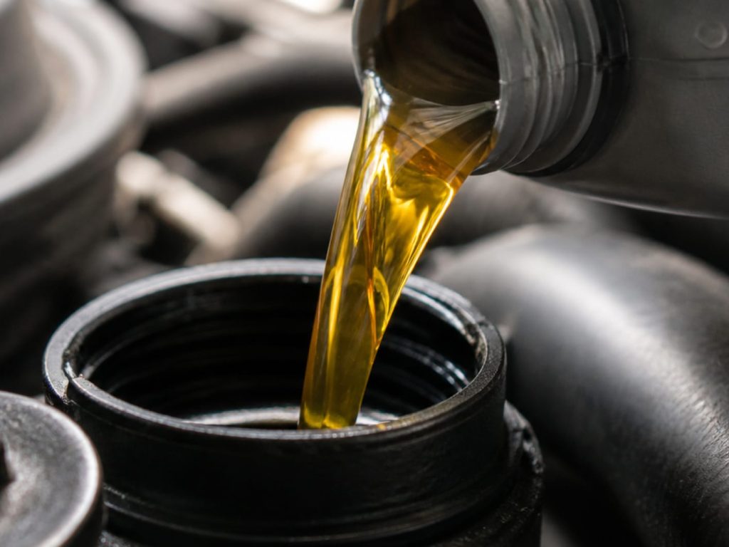 closeup of oil pouring out of bottle